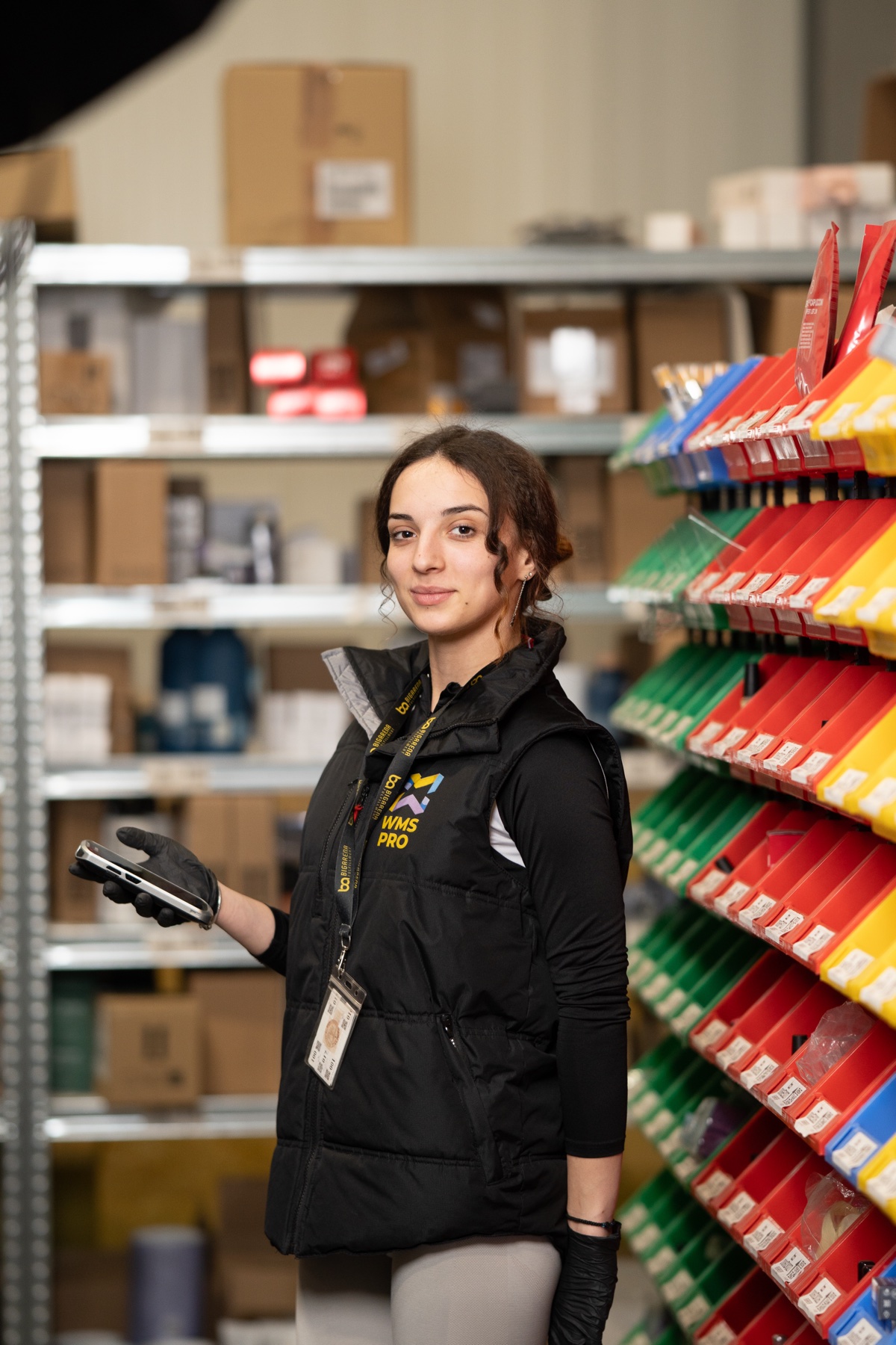 Warehouse employee at the BigArena fulfillment center with a handheld barcode scanner